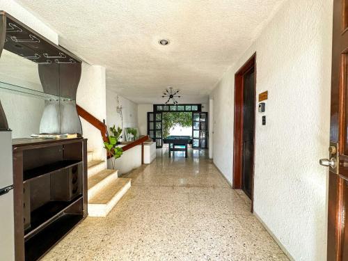 a hallway of a house with a table in it at Escapada Calida para 4 en Zona Campestre Merida in Chuburná de Hidalgo