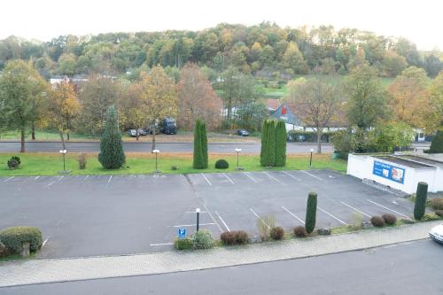 a parking lot with a bunch of cars in it at Hotel Jägerhof in Bad Hersfeld