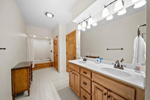a bathroom with a sink and a large mirror at Chetola: Sierra 1 in Blowing Rock