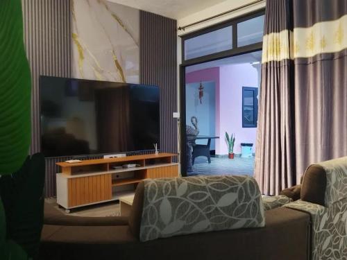 a living room with a large flat screen tv at Charming Villa with Pool in Souillac in Souillac