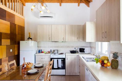 a kitchen with a white refrigerator and a table at Melodia in Fternón