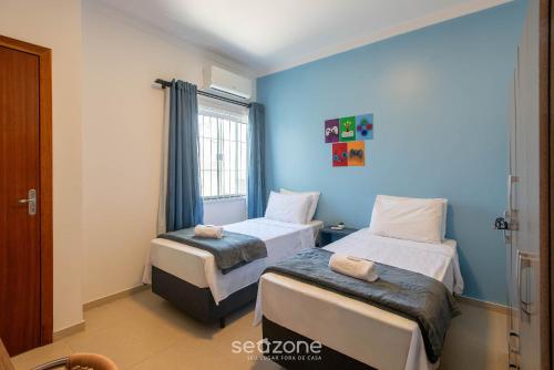 Кровать или кровати в номере Casa 2Q c/ churrasq. 600m orla MCA0609