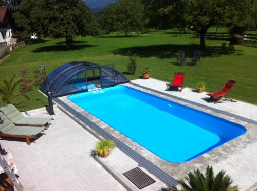 an overhead view of a swimming pool with two lawn chairs at Apartment Bachmann in Bludenz