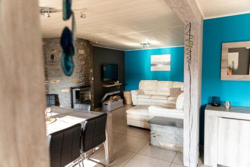 a living room with a couch and a table at l'hôt'antique in Vielsalm