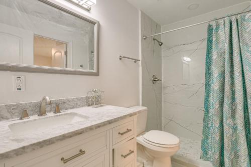 a bathroom with a toilet and a sink and a shower at Pet-Friendly Duplex with Large Yard in Fort Myers! in Fort Myers