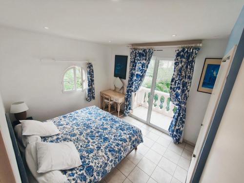 a bedroom with two beds and a window with a view at Appartement La Potinière in Saint-Raphaël