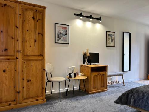 a bedroom with a bed and a desk and chairs at Devonshire Lodge Chalet in Bansko