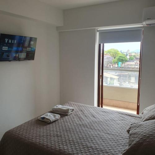 a bedroom with a bed and a large window at Monoambiuente equipado para 2 personas en San Miguel de Tucumán in San Miguel de Tucumán