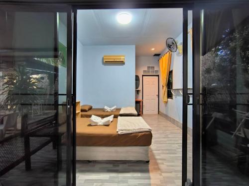 a small room with two beds and a hallway at PhuketAirportCamping in Mai Khao Beach