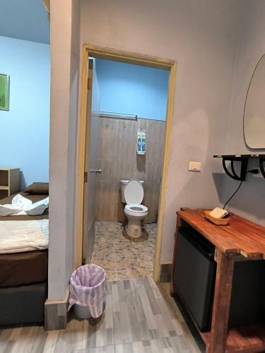 a bathroom with a toilet in a room at PhuketAirportCamping in Mai Khao Beach