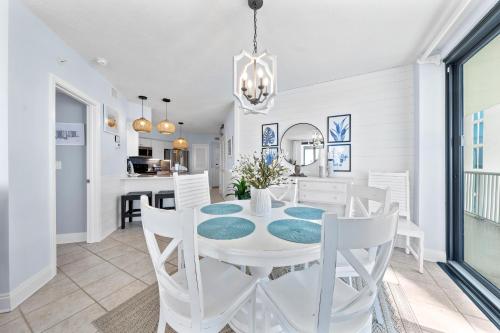 een eetkamer met een witte tafel en witte stoelen bij Sunrise Serinity Summer House 1101A in Orange Beach