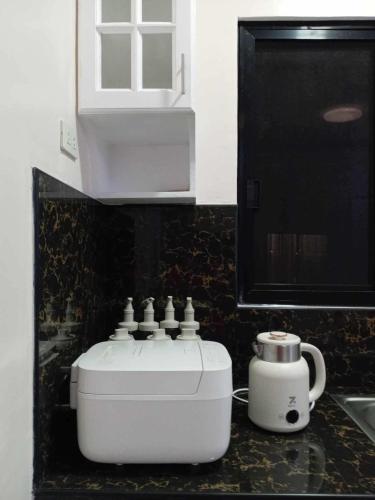 a kitchen counter with a coffee maker on it at Cozy Home in Dipolog by Aveinz in Dipolog