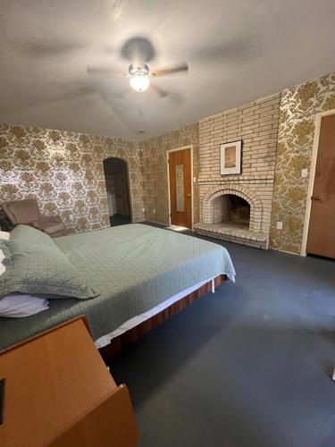 a bedroom with a large bed and a fireplace at The Jefferson Suite in Eagle Pass
