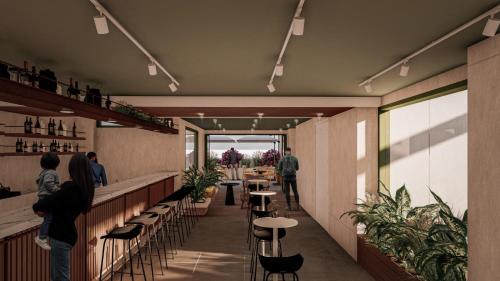 a restaurant with tables and chairs and people walking around at LAS CONDES Hotel in Tacna