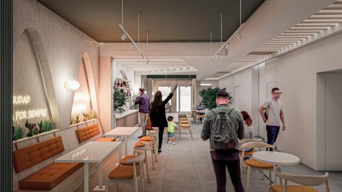 a group of people standing in a room with tables and chairs at LAS CONDES Hotel in Tacna