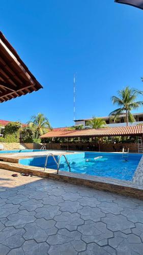 a large swimming pool in front of a building at Hotel Sol del Oriente Pucallpa in Pucallpa