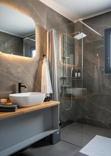 a bathroom with a sink and a shower at Elegant Dream Suites in Agia Anna