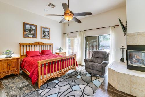 a bedroom with a red bed and a fireplace at Groups Welcome! Home w/ Pool + Patio in N Phoenix in Phoenix