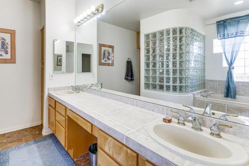 a bathroom with two sinks and a large mirror at Groups Welcome! Home w/ Pool + Patio in N Phoenix in Phoenix