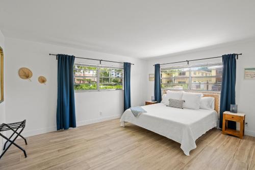 a bedroom with a bed and a large window at Steps To Beach! 4 Condos In 1- Perfect For Groups in West Palm Beach