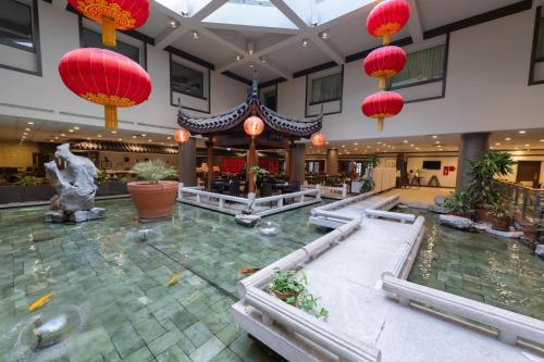 a hotel lobby with a fountain and red lanterns at Holiday Inn Montreal Centre Ville Downtown by IHG in Montréal