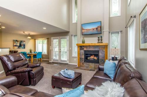 a living room with leather furniture and a fireplace at Union Grove in Salt Lake with Hot Tub and Foosball in Midvale