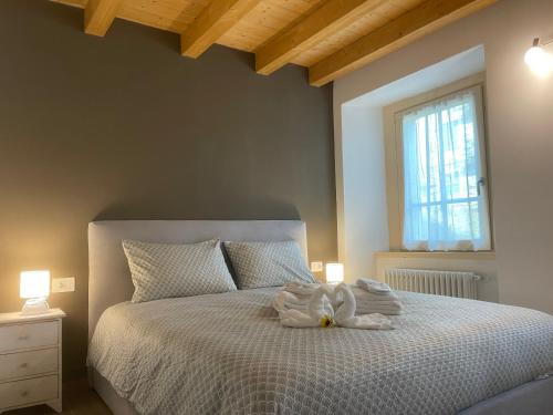 a bedroom with a bed with towels on it at La Primula Panoramic View - Valmalenco in Chiesa in Valmalenco
