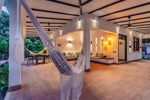 a room with a hammock in a house at Senda Beach House Tayrona in Buritaca