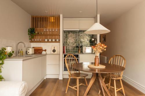 a kitchen and dining room with a table and chairs at Leworth Apartments, Windsor in Windsor