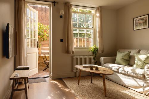 a living room with a couch and a table at Leworth Apartments, Windsor in Windsor