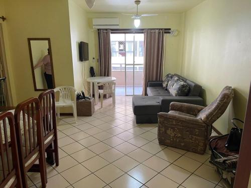 een woonkamer met een bank en stoelen bij Apartamento Central Edifício Vale do Reno BC in Balneário Camboriú