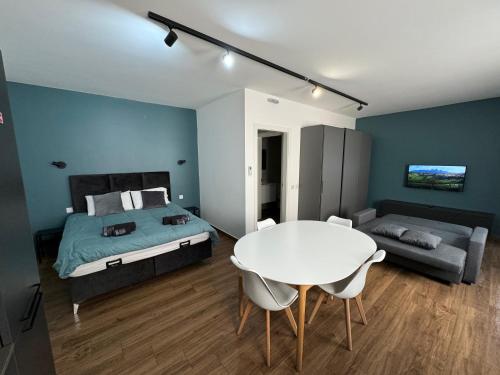 a bedroom with a bed and a table and a couch at Modern Studio in Central Victoria in Victoria