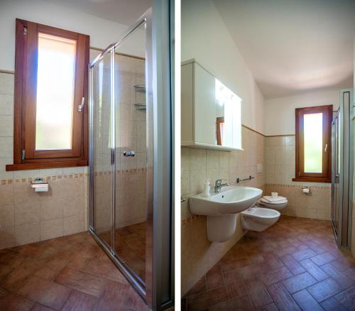 a bathroom with a toilet and a sink and a shower at Li Chessi Blu Villetta Familiare con Piscina in Costa Paradiso