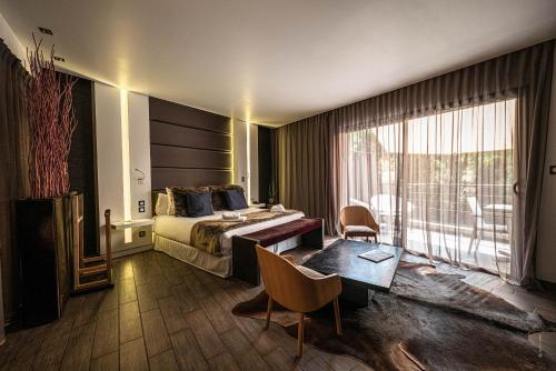 a hotel room with a bed and a table at Hôtel Le Parc - La Table de Franck Putelat in Carcassonne