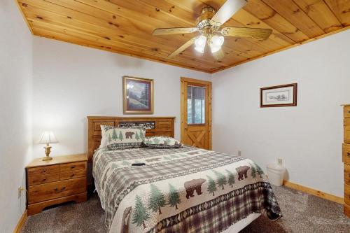 a bedroom with a bed and a ceiling fan at Hickory Hill in Pigeon Forge