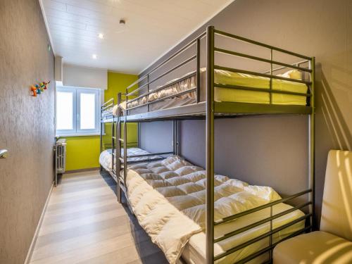 two bunk beds in a room with yellow walls at Zeezicht GV in Galopen