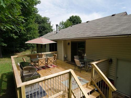 a deck with a table and chairs on a house at Ole and Lena's Place in Bayfield