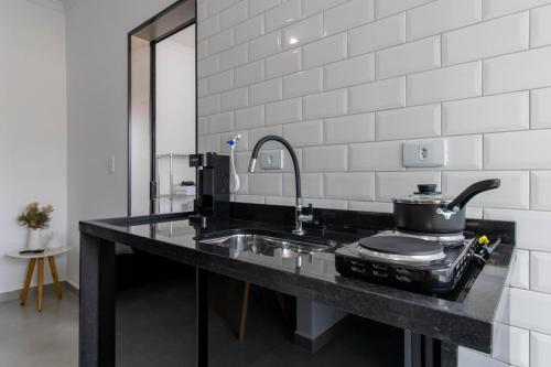 a kitchen counter with a sink and a pot on it at 0804 Orquídea Studio Próx GRU e Estação Cecap in Guarulhos