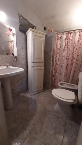 a bathroom with a sink and a toilet and a shower at Casa Los Abuelos in La Granja