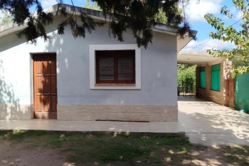 a white house with a door and a window at Casa Los Abuelos in La Granja