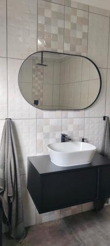 a bathroom with a sink and a mirror at 7atSapele in Germiston