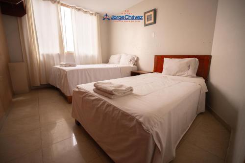 Un ou plusieurs lits dans un hébergement de l'établissement Hotel JORGE CHAVEZ