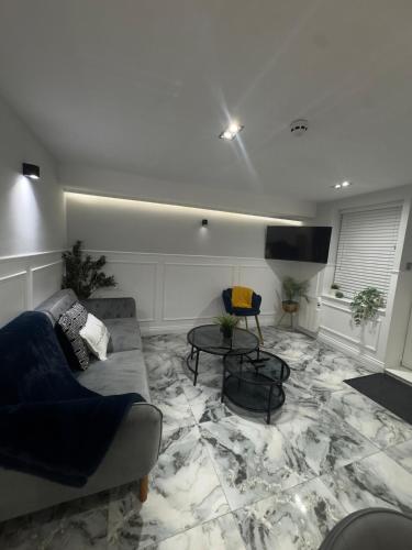 a living room with a couch and a table at Cloud Quarters II in Wakefield