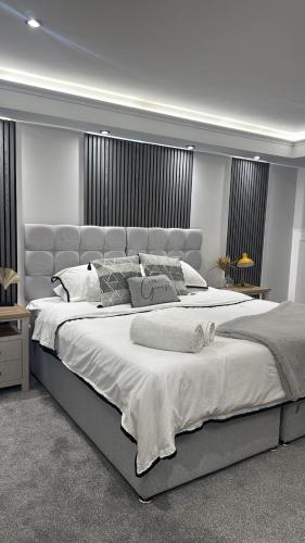 a large bedroom with a large bed with white sheets at Cloud Quarters II in Wakefield