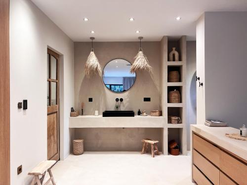 a bathroom with a sink and a mirror at Villa Victoire - Mini villas avec terrasse privée in Vauvenargues