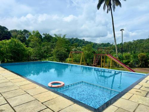 an empty swimming pool with a roller coaster at Karlad Lake Palace Waterfront Resort in Tariyod