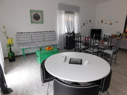 a living room with a white table and chairs at B&B Affittacamere La Dolce Mela in Francavilla di Sicilia