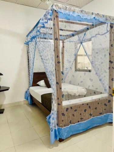 a bedroom with a canopy bed in a room at Sahas Homestay in Tangalle