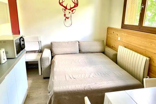 Una pequeña habitación con una cama en una cocina. en Bright apartment near the slopes, en La Salle-les-Alpes