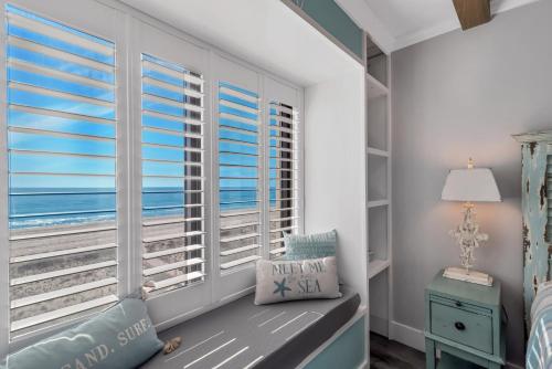 a bedroom with a window with the ocean at Island Winds East Condo 402 in Gulf Shores